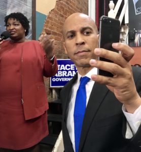 Sen. Cory Booker, D-NJ, demonstrates his cell skills with Georgia gubernatorial nominee Stacey Abrams (Bob Ingle photo)